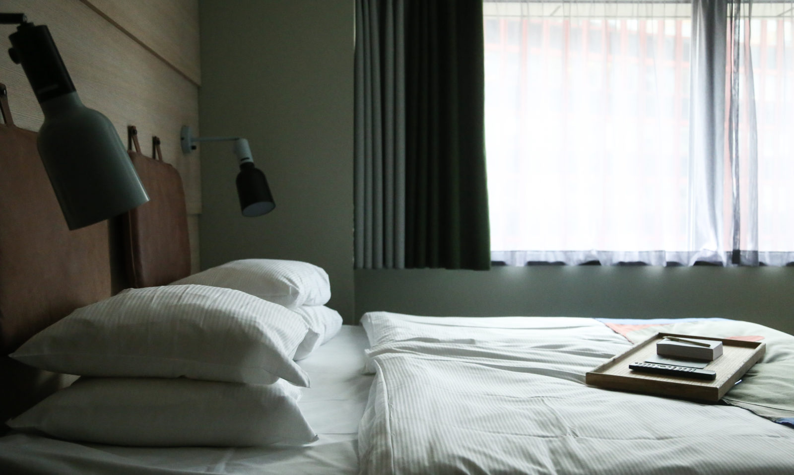 Room with a window and king size bed with white fresh sheets at Hobo Hotel in Stockholm